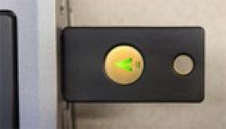 YubiKey plugged into a USB port on a computer that has been activated and is lit-up ready to be pressed